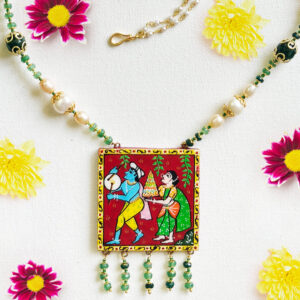 Front view of Bathukamma Bloom necklace by Bujjis with hand-painted pendant of Bathukamma procession, pearls, jade beads, and gold-detailed accents.