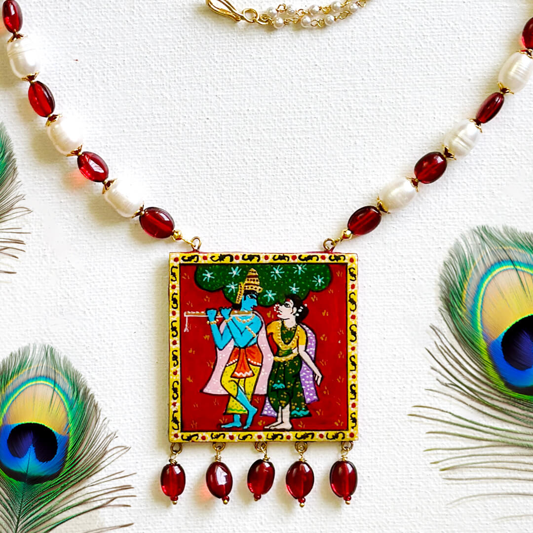 Front View of Eternal Love necklace by Bujjis with hand-painted Radha Krishna Cheriyal pendant, real pearls, and glass beads.