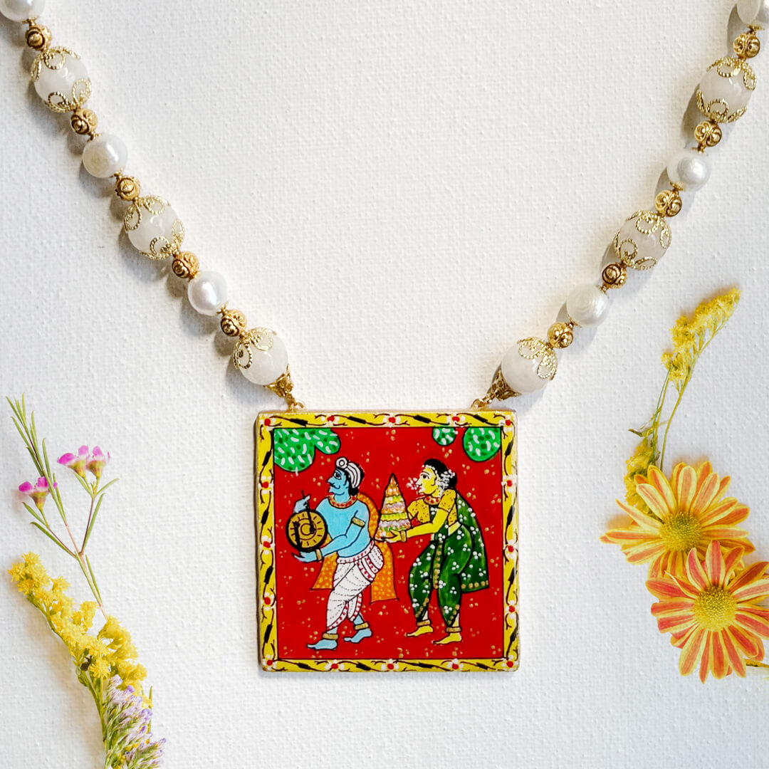 Front View of Traditional Melody necklace by Bujjis with Bathukamma scene, red backdrop, hand-painted pendant, pearls, and white jade beads.