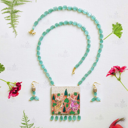 Front View of Forest Muse necklace by Bujjis with Kashmiri art square pendant, animal motifs, Monalisa beads, light blue-green stones, and earrings.
