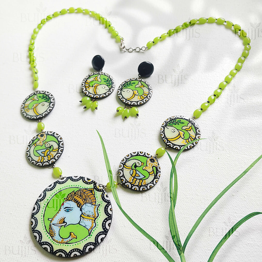 Ganesha Elegance necklace by Bujjis with hand-painted Madhubani Ganesha on polymer clay and green glass beads.