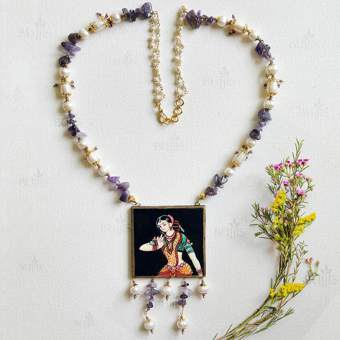 Front View of Regal Grace necklace by Bujjis featuring hand-painted Nirmal art of an Indian dancer, accented with pearls and amethyst stones.
