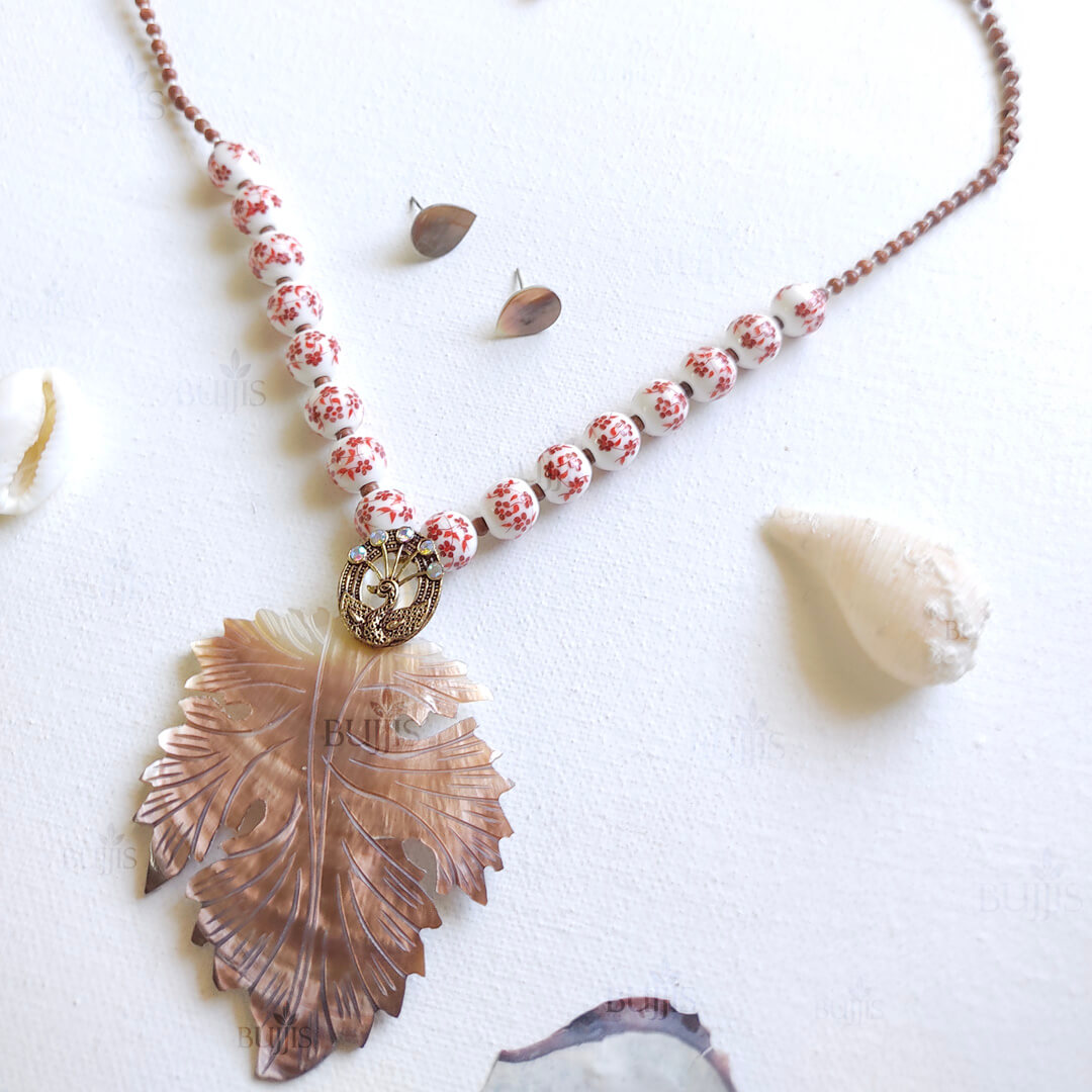 Verdant Bloom jewelry set by Bujjis with floral ceramic beads and carved leaf pendant