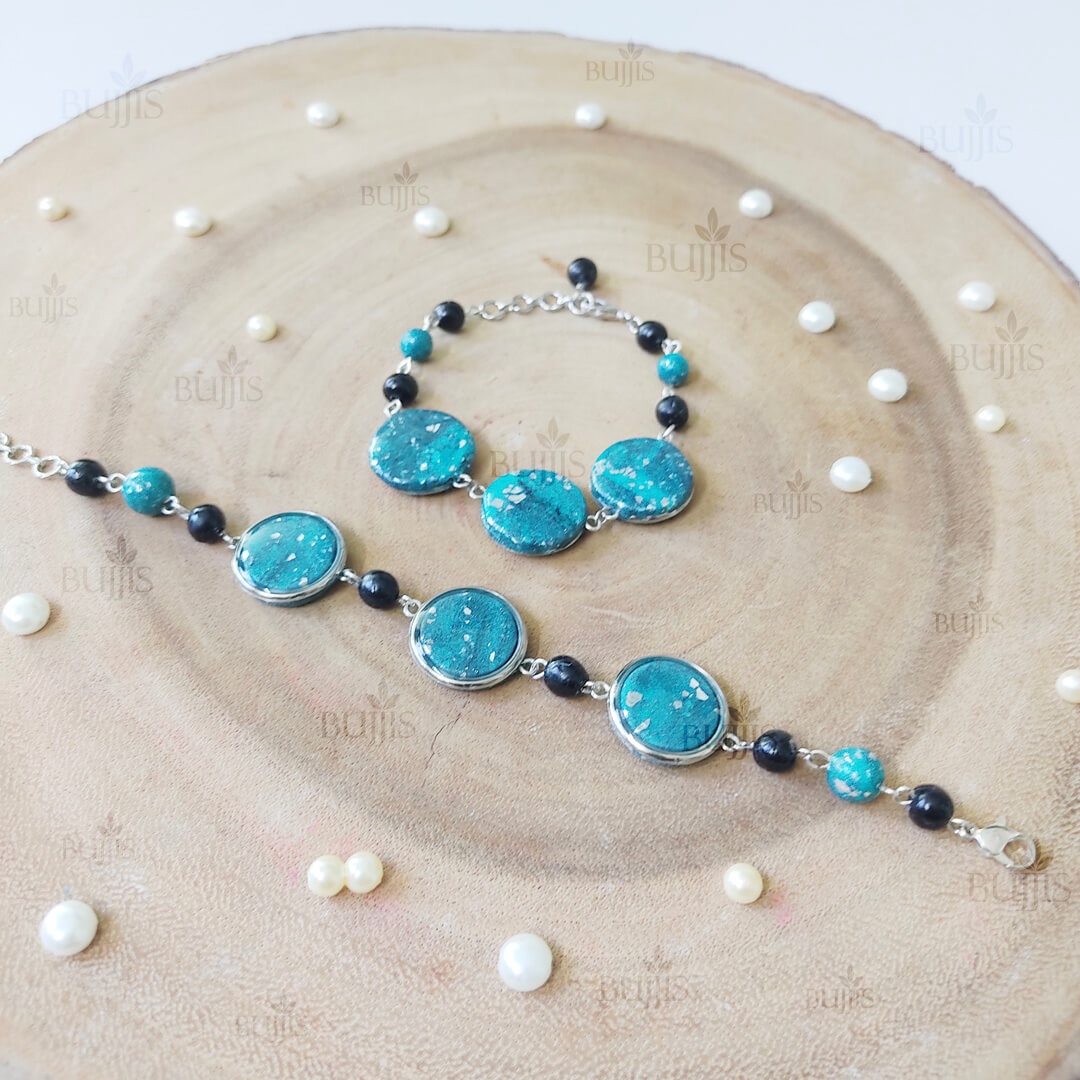 Ocean Glint bracelet and necklace set by Bujjis with turquoise and black beads, silver flakes, and handcrafted artistic detailing.