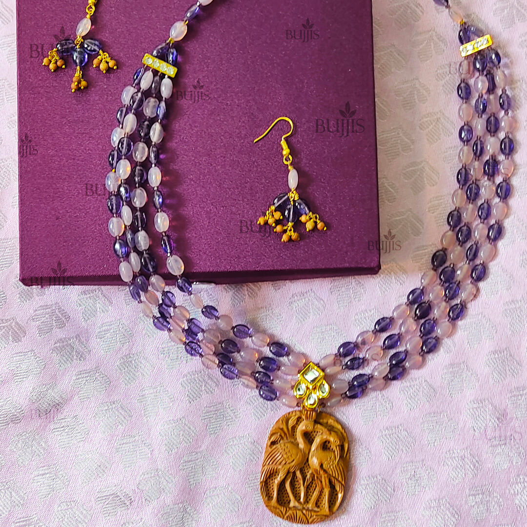 Zen Harmony jewelry set by Bujjis with sandalwood beads, purple accents, and a twin swan pendant.