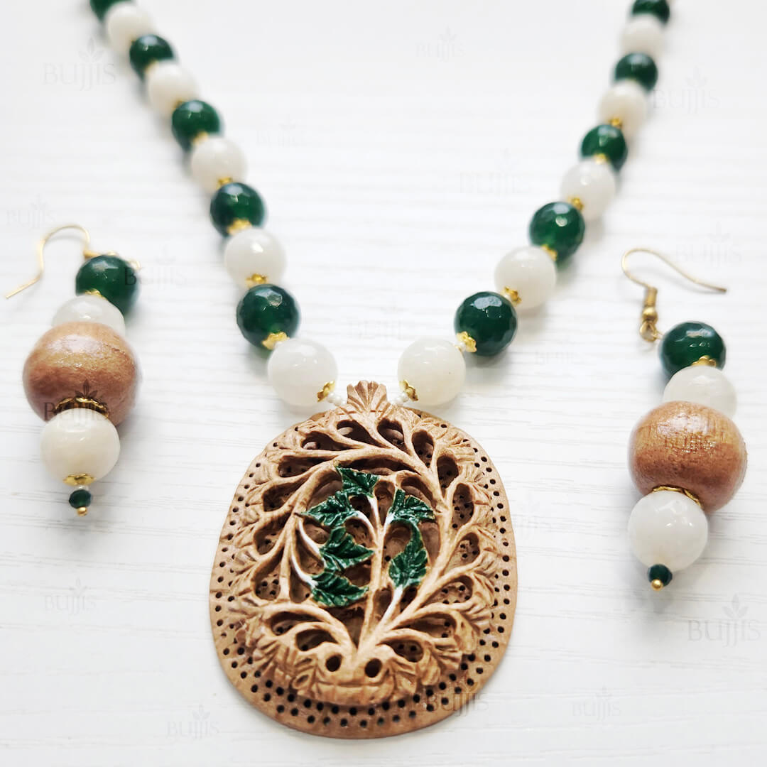 Leaf Glow Necklace & Earring Set featuring carved wooden pendant with leafy design, green and white beads, and golden spacers.