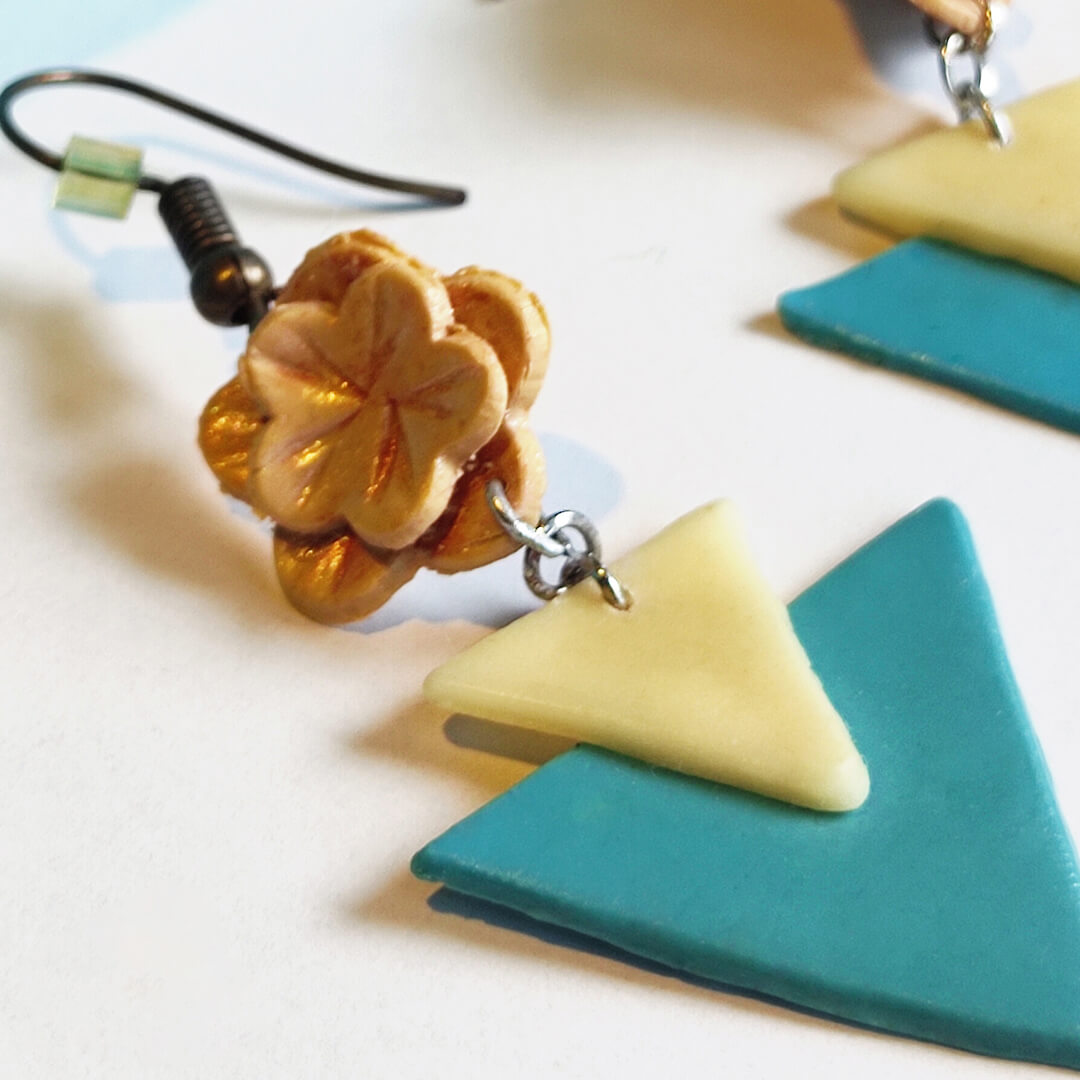 Bloom Blocks polymer clay earrings with teal and ivory triangles and gold floral accents – handcrafted statement earrings from Bujjis.in