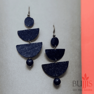 Close-up image of blue geometric polymer clay earrings with layered shapes, designed for lightweight, modern, and stylish wear by Bujjis.