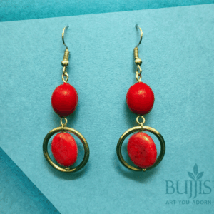 Red Bead Hoop Earrings with gold-tone rings on blue background – handcrafted stylish jewelry by Bujjis