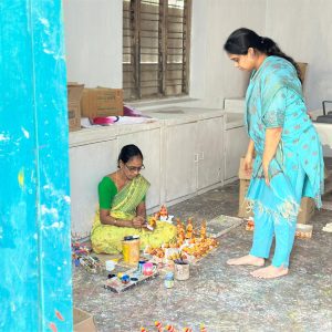 "A Bujjis team member discussing designs with a female artisan, collaborating on the creation of wearable Indian art jewellery."