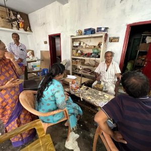 "Artisans and the Bujjis team in a collaborative discussion, sharing ideas and designs for wearable Indian art jewellery."