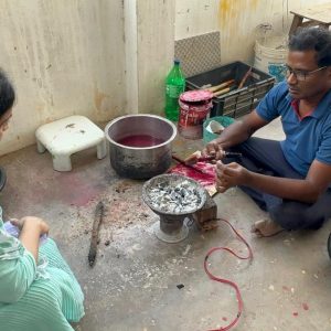 Artisan painting miniature Indian art designs for Bujjis wearable jewellery